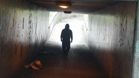 Silhouetted Man Walks Through Underpass Stock Footage 39503878