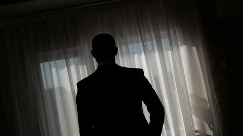 Silhouetted men by the window Stock Footage