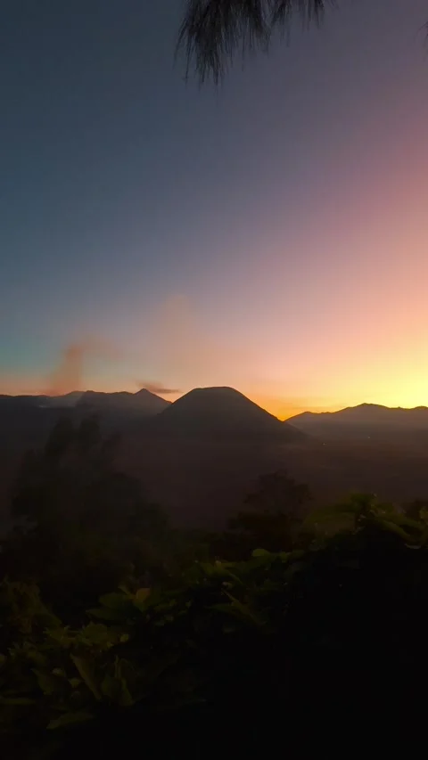 Silhouetted Mount Bromo and Tengger Caldera During Sunset In East Java Vídeo Stock 321914558