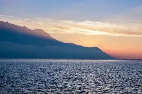 Silhouetted mountains at sunset. Stock Photos