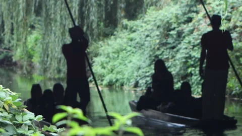 Silhouetted punt boats navigating tree-lined river with passengers in Canterbury 库存影片 348699792