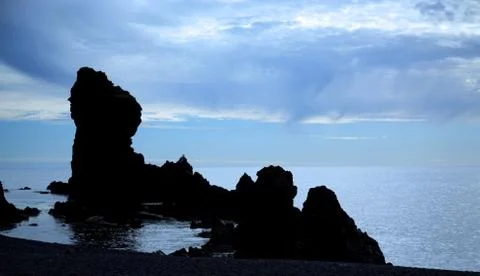 Silhouetted rocks on Dritvik beach Stock Photos