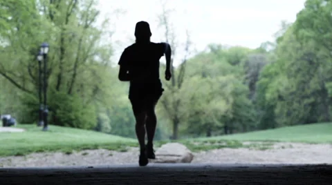 Silhouetted runner in 240 fps slow motion. Video stock 63435136