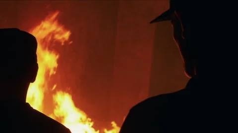 Silhouetted soldier watching a massive explosion Видео 334380618