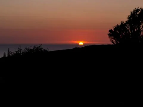 Silhouetted sunset Stock Photos