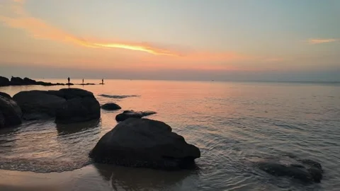 Silhouetted Sunset Serenity on Ocean Rocks Stock Footage 259255495