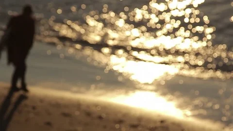 Silhouetted surfer walking on beach Stock Footage 71206997