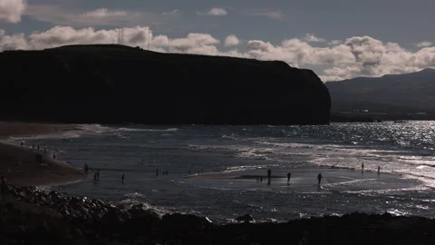 Silhouetted Swimmers on Sand Patch at Low Tide. Ribeira Grande,Sao Miguel,Azores Stock Footage 239866532