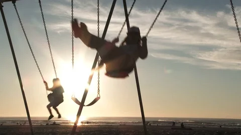 Silhouetted Swings At Sunset Stock Footage 81002959