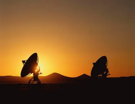 Silhouetted VLA Very Large Array radio telescope dishes Stock Photos