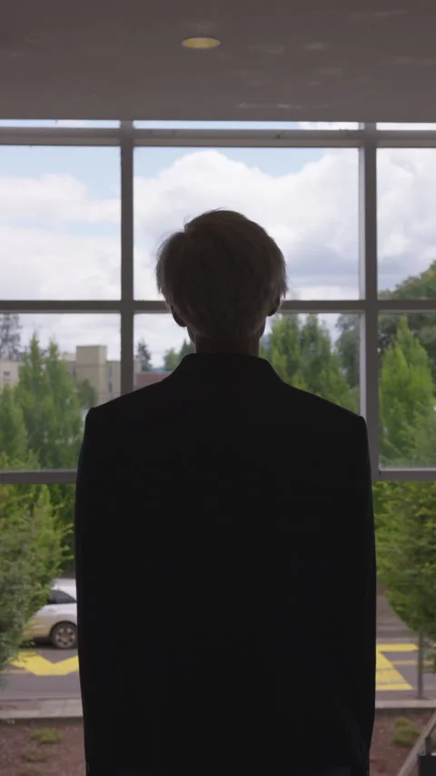Silhouetted Woman with Short Pixie Cut Looking Toward City in Natural Light Stock Footage 208778426