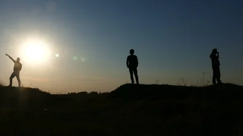 Silhouettes of 3 men posing for a photo Stock Footage 87997738