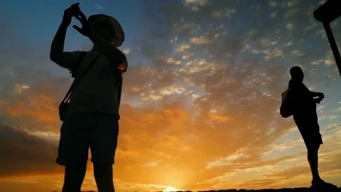 Silhouettes against a background of sunsets Video stock 74425563