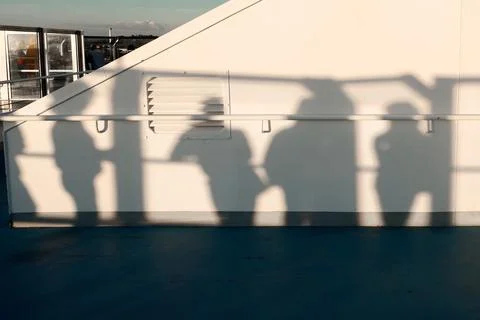 Silhouettes cast by sunlight on deck Stock Photos