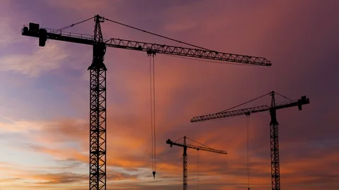 Silhouettes of construction cranes on the background of a beautiful sunset sky. Stock Footage 123338460