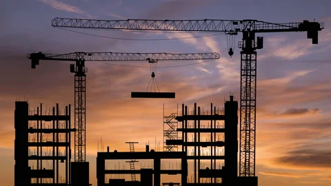 Silhouettes of construction cranes on the background of a sunset sky. Timelapse. Stock Footage 165727743