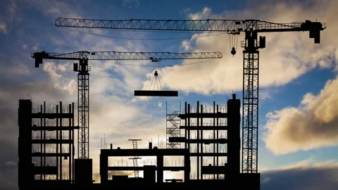 Silhouettes of construction cranes on the background of a sunset sky. Timelapse. Stock Footage 165728960