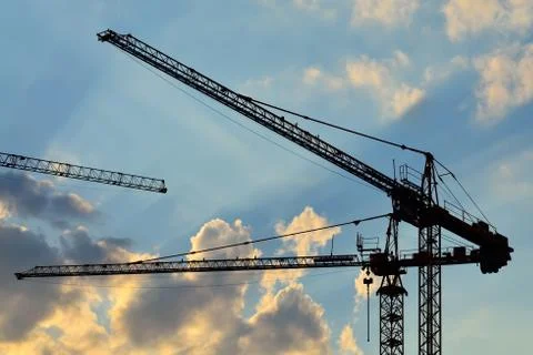 Silhouettes construction cranes Stock Photos