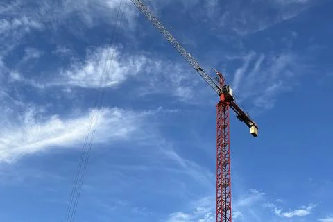 Silhouettes of construction cranes Stock Photos