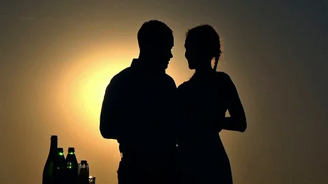 Silhouettes of a couple at sunset Stock Footage 98463656