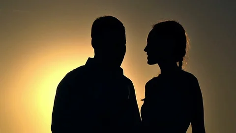 Silhouettes of a couple at sunset Stock Footage 98791633