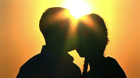 Silhouettes of a couple at sunset Stock Footage 99250106