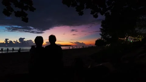 Silhouettes of couple at sunset (Timelapse) Stock Footage 300696318