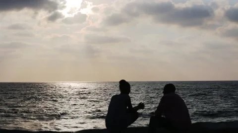 Silhouettes of couples  communicate in the evening on the sea Stock-Footage 52375700