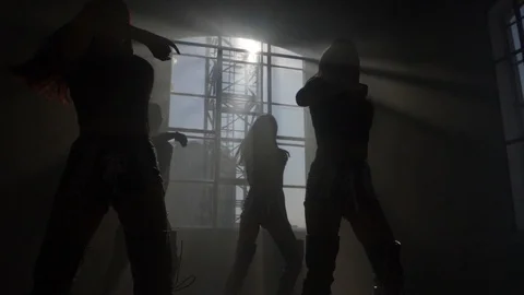 Silhouettes dancing in the sun choreography slow motion contre jour Stock Footage 125530725