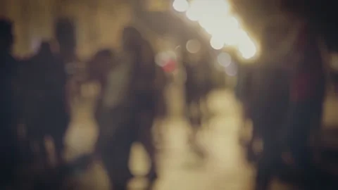 Silhouettes defocused of many couples dancind outside in slomo Stock Footage 145530396