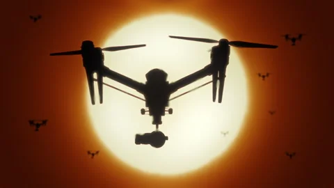 Silhouettes drones flying against warm sun in desert slow motion animation Stock Footage 277550556