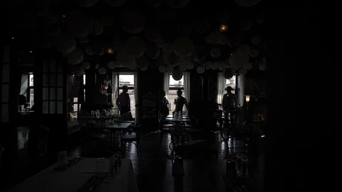 Silhouettes of four men talking near window Stock Footage