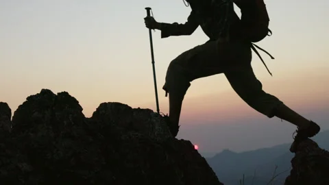 Silhouettes a group of  climbing on mountain and helping. Help and assistan.. Stock Footage 336975564