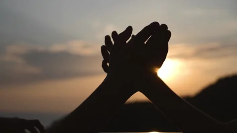 Silhouettes of hands during sunset shaking each other. 스톡 동영상 151670829