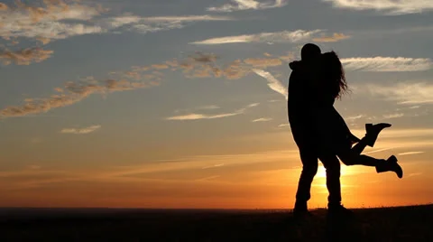 Silhouettes of a Happy Couple at Sunset Stock Footage