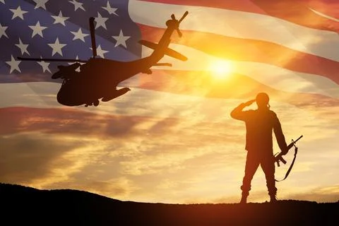 Silhouettes of helicopter on background of sunset. Stock Photos