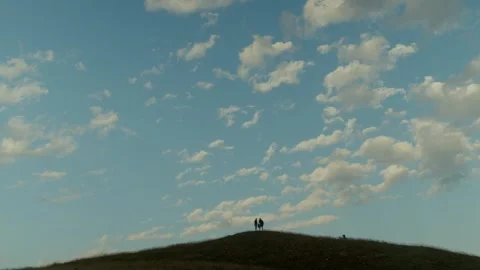 Silhouettes on the Hilltop, Under a Vast Cloud-Filled Sky Vidéo 284430022