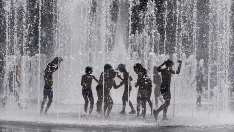 Silhouettes, Kids Having Fun Between Water Splash in Fountain on Street. Heat 스톡 동영상 125760074
