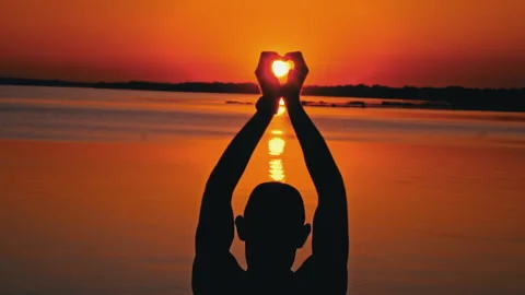 Silhouettes of a Man with Raised Hands at Sunset Alone Stock Footage 252799998
