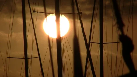 Silhouettes of masts on a background of a solar disk Stockbeeldmateriaal 88911977