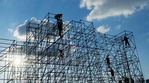 Silhouettes of men engineer worker at construction site. Workers at sunset Stock Footage 109150001