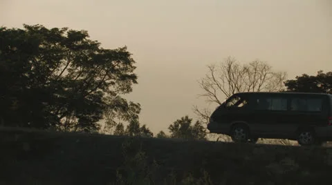 Silhouettes of a minibus and trees Stock Footage 26094093