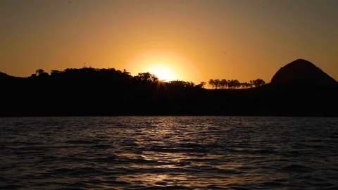 Silhouettes of mountains and trees with sea at sunset, Guanabara bay, Brazil Stock Footage 123736900