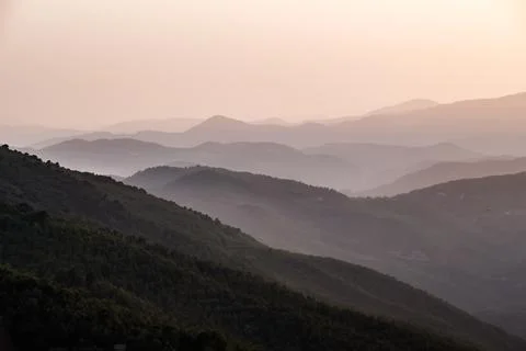 Silhouettes of mountains at sunset Stock Photos