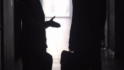 Silhouettes of Office Workers Shaking Hands and Walking along Hallway Stock Footage 100792299