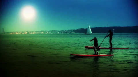 Silhouettes paddling on the river at sunset Video stock 35311716