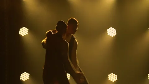 Silhouettes of a pair of dancers performing elements of Argentine dance appear Stock Footage 150582936