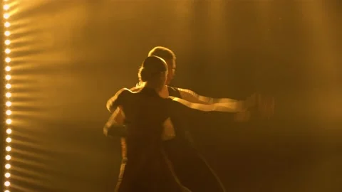 Silhouettes of a pair of dancers performing elements of Argentine dance appear Stock Footage 150583236