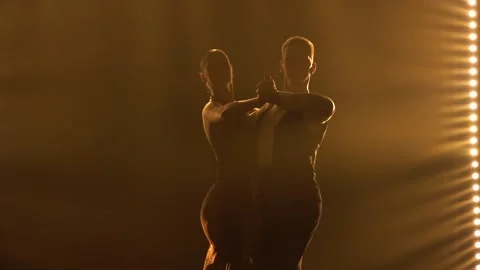 Silhouettes pair of dancers performing elements of Argentine dance appear Stock Footage 150585319