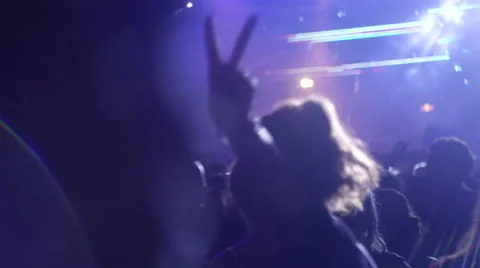 Silhouettes of people dancing at a concert Stock Footage 63083328